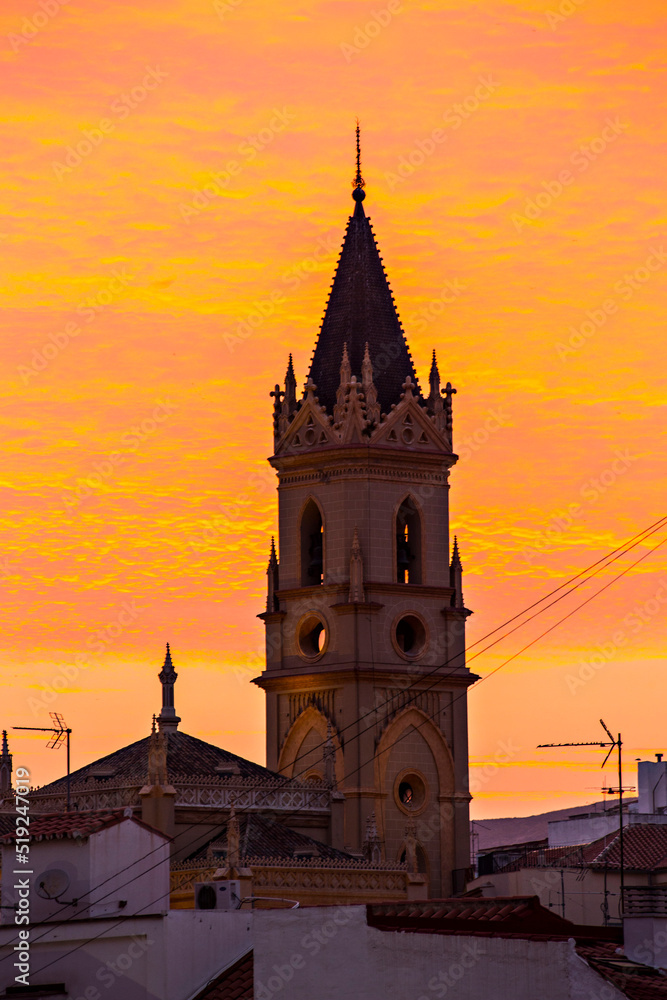 Spectacular sunset with tower silhouette of La Iglesia de San Pablo in Malaga, Andalusia, Spain