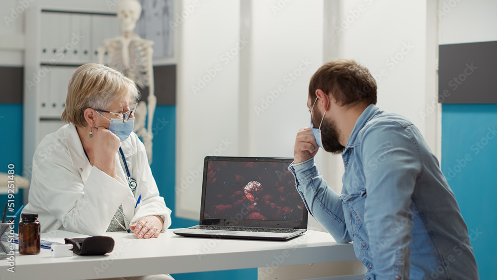 Obraz premium Physician analyzing virus animation on laptop with sick patient during covid 19 pandemic in checkup cabinet. Examination of coronavirus illustration for prevention and recovery on computer.