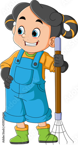 The happy girl is holding a rake and ready to clean while smiling