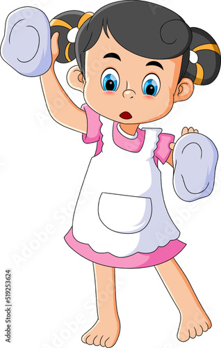 The little girl is cleaning the window with mop and wearing apron