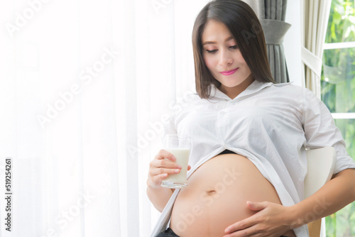 pregnant woman Holding a glass of fresh milk for healthcare Free Download pregnant woman Holding a glass of fresh milk for healthcare - GFXLoad