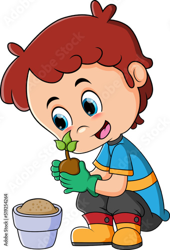 The happy boy is planting and growing the plant in the flower pot