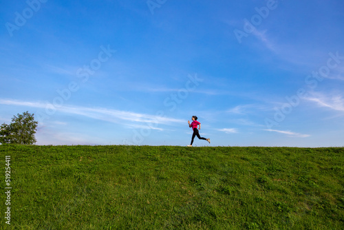 Young Asian girls jogging for fitness in the open grass