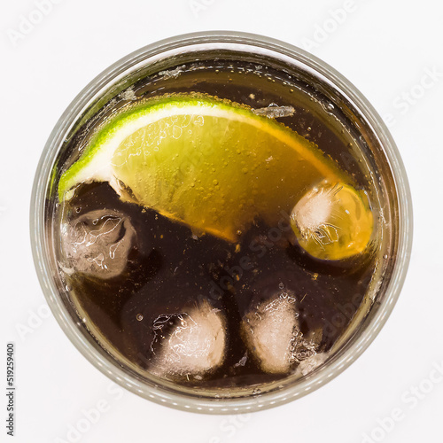 Alcoholic cocktail Cuba Libre in a glass on a white background