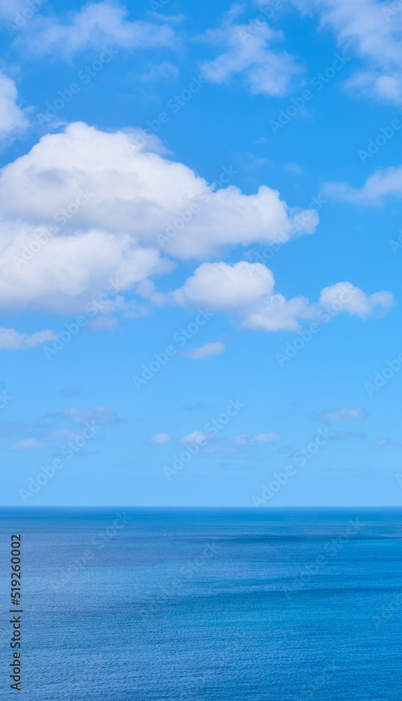Copy space at the sea with a cloudy blue sky background above the horizon. Panoramic of calm ocean waters across a beach shore. Peaceful scenic coastal landscape for a relaxing and zen summer getaway Copy space at the sea with a cloudy blue sky background above the horizon. Panoramic of calm ocean waters across a beach shore. Peaceful scenic coastal landscape for a relaxing and zen summer getaway