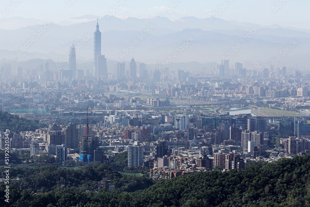 Aerial view of Taipei 101 tower in XinYi District, and Keelung River, capital city of Taiwan, with heavily polluted air on a hazy winter day ~ Air pollution level of PM2.5 classified as 