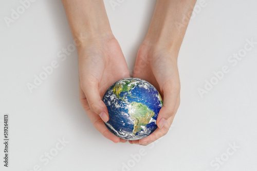 Human hand holding earth. Protect the environment to save the world concept. Elements of this image furnished by NASA.