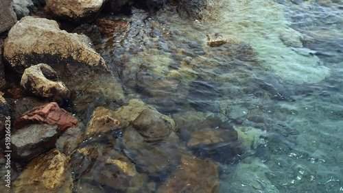 Wallpaper Mural Stone sea shore with a beautiful calm surf of clear water. Seascape. Torontodigital.ca