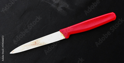 a knife with red handle