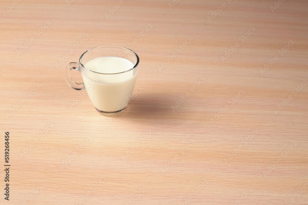 Glass of Milk on a Wooden Background. Diet Concept. Top Angle View. Glass of Milk on a Wooden Background. Diet Concept. Top Angle View.
