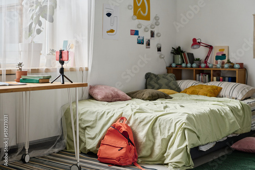Canvastavla Horizontal image of teenage room with cozy bed and table with smartphone on trip
