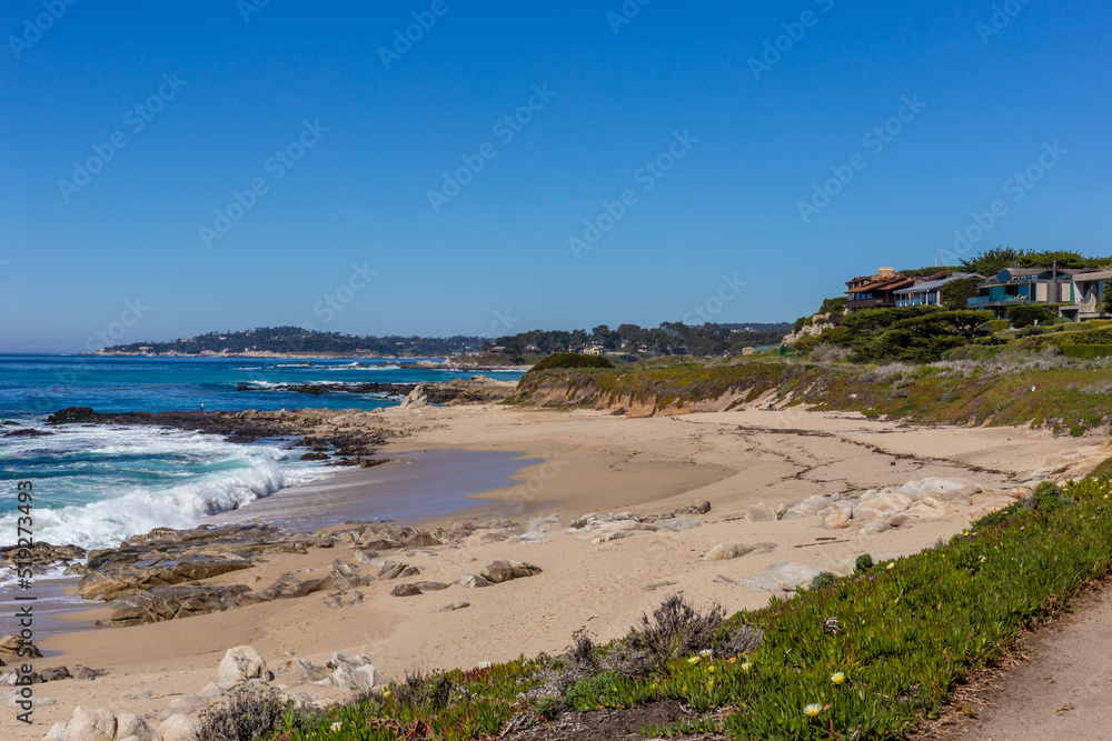 A view on Pacific ocean coast with blue sky and water and waves