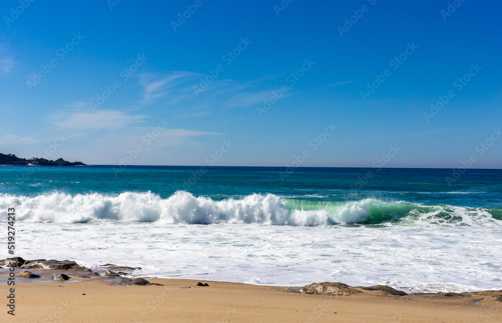 A view on Pacific ocean with blue water and waves