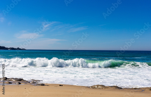 A view on Pacific ocean with blue water and waves