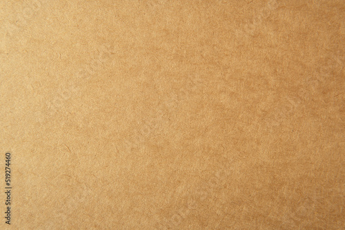 Corrugated cardboard box light brown color on blank craft paper texture background made from natural recycled material design for packaging or website page