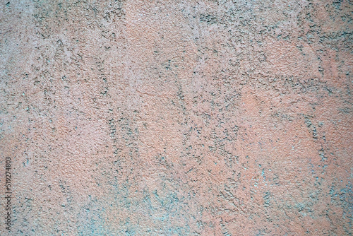 Interior background with texture of old painted pink grey concrete wall.
