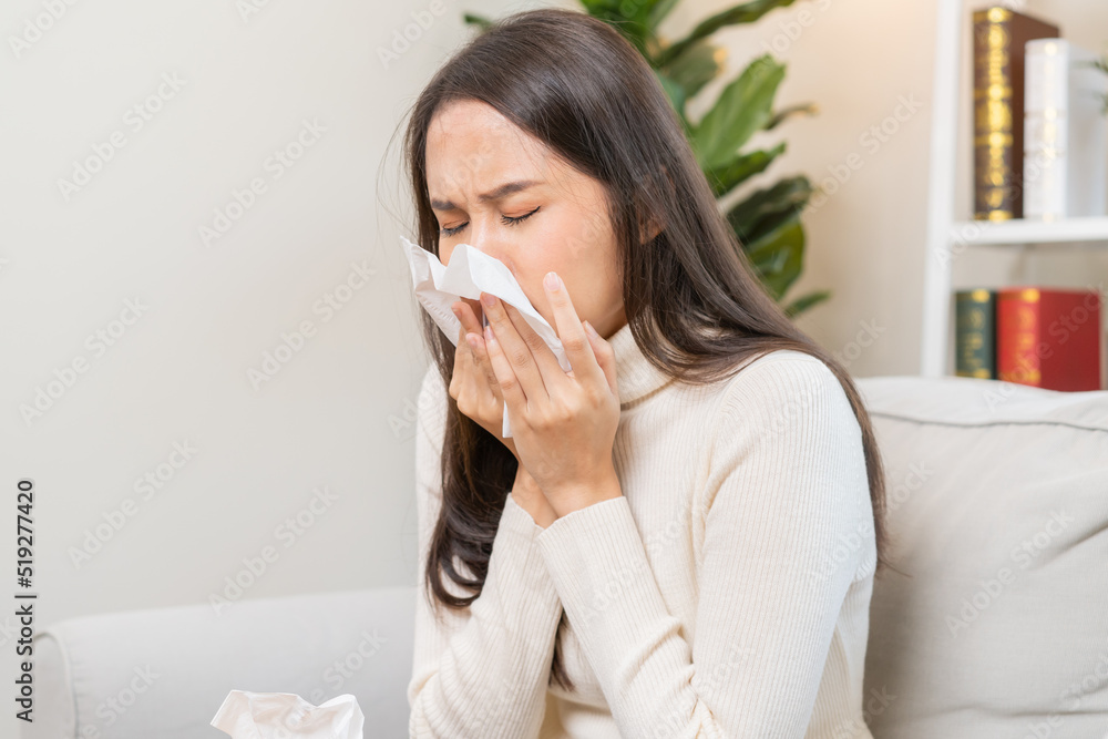 Sick, Coronavirus covid-19 asian young woman, girl headache under blanket have a fever, flu and use tissues paper sneezing nose, runny sitting on sofa bed at home. Health care on virus person. Sick, Coronavirus covid-19 asian young woman, girl headache under blanket have a fever, flu and use tissues paper sneezing nose, runny sitting on sofa bed at home. Health care on virus person.