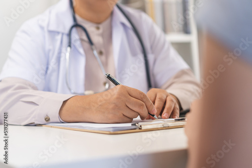 Mature  senior asian physician  psychiatrist woman doctor hand in take note  listen problem consulting concerned with young patient at clinic  hospital. Health care  appointment check up medical.