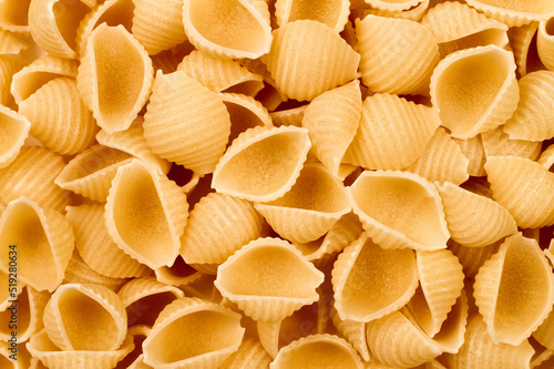 Raw pasta in the form of shells.