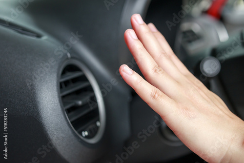 hand checking air conditioner system inside the car