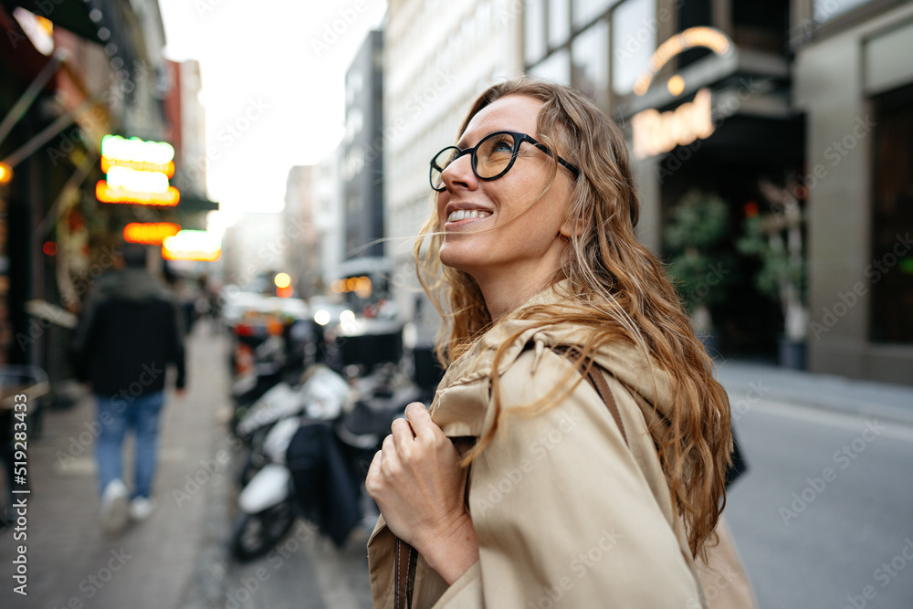 Portrait of caucasian female business person in eyeglasses on city street