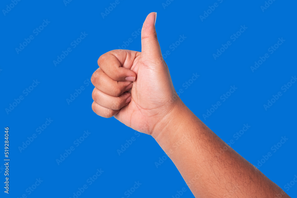 person's hand showing thumbs up, concept showing good appreciation, and okay or agree, isolated on blue background person's hand showing thumbs up, concept showing good appreciation, and okay or agree, isolated on blue background