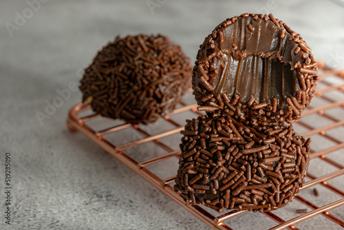 bitten Creamy Brazilian Brigadeiro, a traditional sweet from Brazil. dessert with sprinkles photo