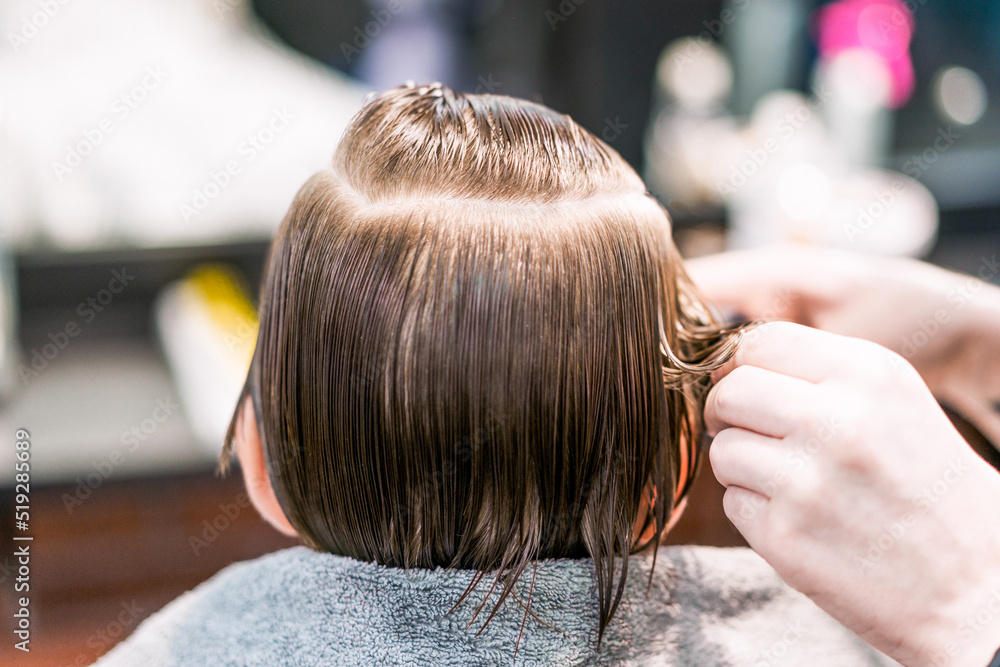 Naklejka premium A closeup of boy's wet hair from his nape.