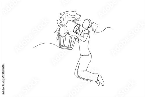 Continuous one line drawing happy young woman jumping and carrying heavy basket of clothes. Laundry service concept. Single line draw design vector graphic illustration.