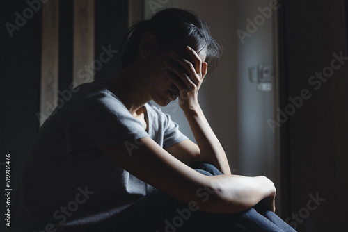 Bild auf Leinwand Sad woman sitting alone, woman on the bed, stress, suicidal thoughts, human traf