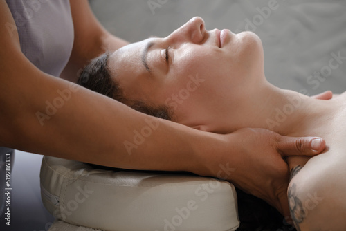 face massage with oil in traditional style made by professional beauty therapist women. anti-age massage