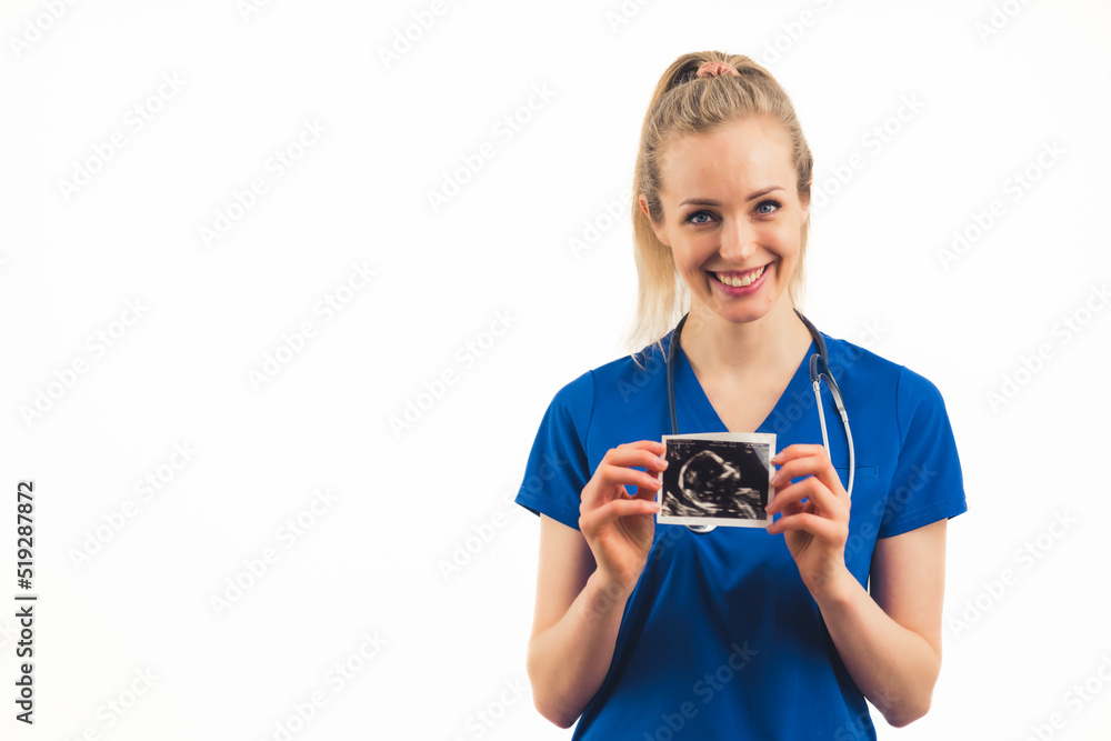 A smiling caucasian nurse showing a photo of an embryo - closeup. High quality photo A smiling caucasian nurse showing a photo of an embryo - closeup. High quality photo