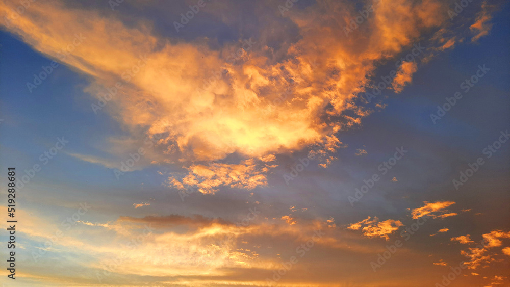 Colorful sunset on the sky with clouds on a warm summer evening.