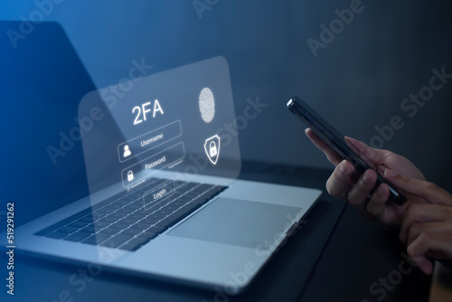Fotografie Person using laptop and touching virtual screen for two-factor authentication fo