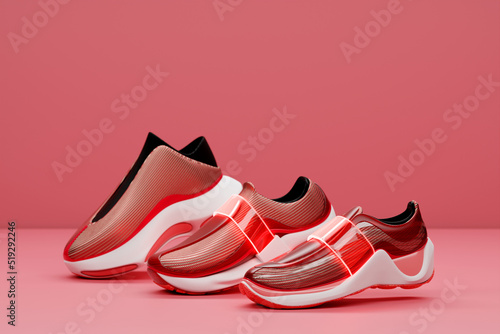 Set of the red sneakers on the sole. The concept of bright fashionable sneakers  3D rendering.