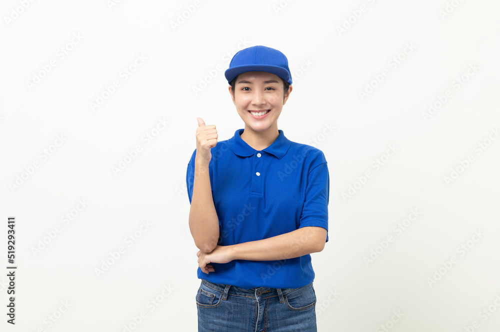 Happy delivery asian woman in blue uniform standing showing thumbs up on isolated white background. Smiling female delivery service worker. Happy delivery asian woman in blue uniform standing showing thumbs up on isolated white background. Smiling female delivery service worker.