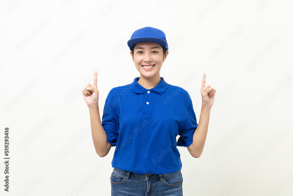 Happy delivery asian woman in blue uniform standing pointing the finger to blank space for text advertise on isolated white background. Smiling female delivery service worker. Happy delivery asian woman in blue uniform standing pointing the finger to blank space for text advertise on isolated white background. Smiling female delivery service worker.