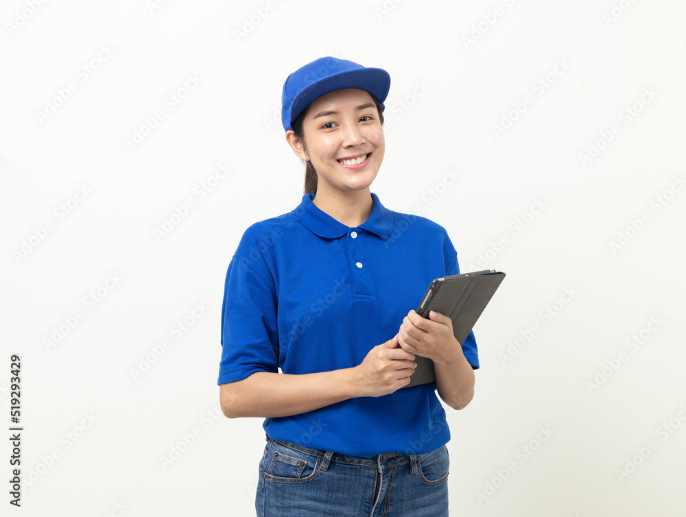 Happy delivery asian woman in blue uniform standing holding digital tablet signing to receive for customer. Female worker checking product with tablet standing on isolated white background. Happy delivery asian woman in blue uniform standing holding digital tablet signing to receive for customer. Female worker checking product with tablet standing on isolated white background.