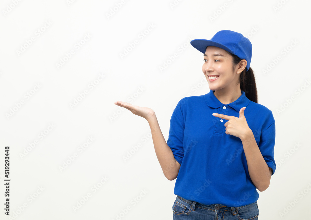Happy delivery asian woman in blue uniform standing pointing the finger to blank space for text advertise on isolated white background. Smiling female delivery service worker. Happy delivery asian woman in blue uniform standing pointing the finger to blank space for text advertise on isolated white background. Smiling female delivery service worker.