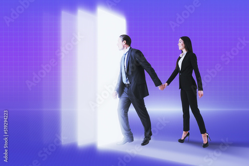 Young businessman and businesswoman walking into metaverse world on glowing background. Meta, technology and innovation concept.