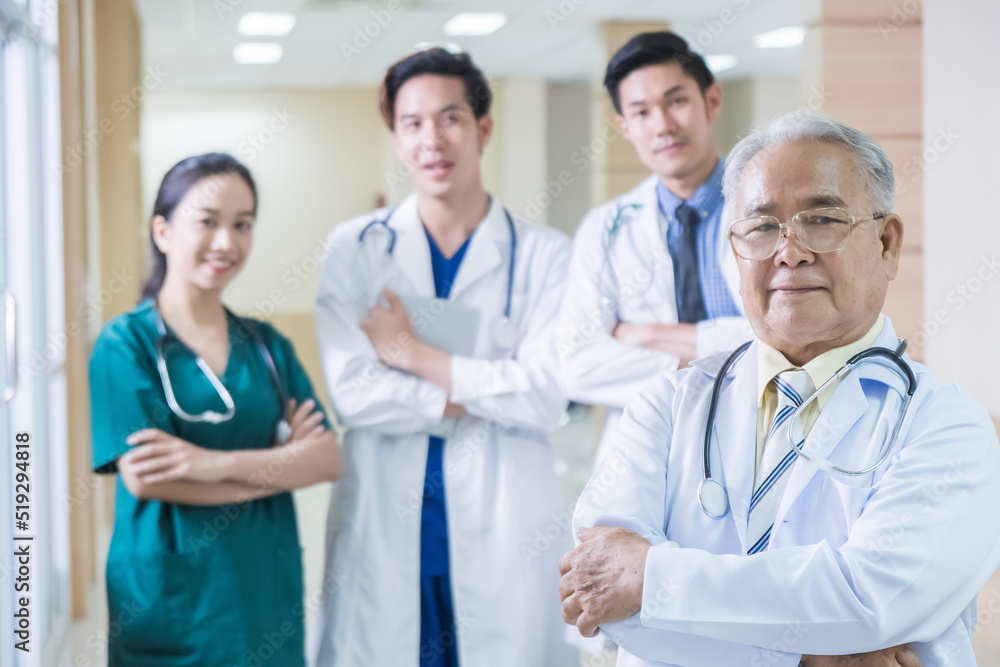 Portrait Group of Asian doctor and nurse crossing arm with smiling. Professional medical team standing in hospital office ward and giving encouragement to patient people after work in recovery room. Portrait Group of Asian doctor and nurse crossing arm with smiling. Professional medical team standing in hospital office ward and giving encouragement to patient people after work in recovery room.