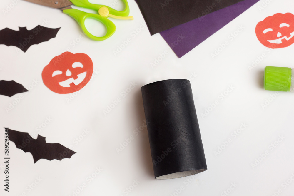 Obraz premium Step by step photo instruction Halloween craft. Step 2 Handmade decoration cat from toilet paper roll. Reuse concept