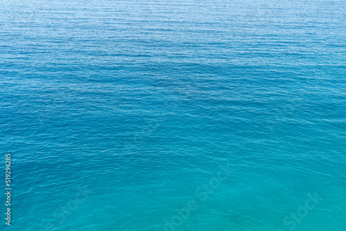 Close up photo of blue and green toned sea surface as a background.