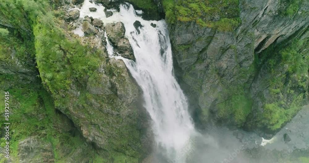 Iconic famous Vøringsfossen waterfall flow in steep narrow Hardanger canyon Iconic famous Vøringsfossen waterfall flow in steep narrow Hardanger canyon