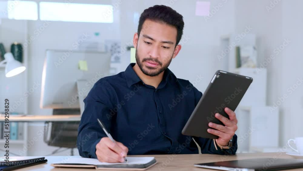 Web developer reading digital tablet, writing notes and thinking of design for user friendly marketing webpage or website for clients. Young creative planning or innovating ideas for company homepage Web developer reading digital tablet, writing notes and thinking of design for user friendly marketing webpage or website for clients. Young creative planning or innovating ideas for company homepage