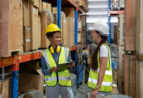 Manager supervisor dicuss with team visit store warehouse checking inventory goods in the shelf before distribute to factory 
 photo