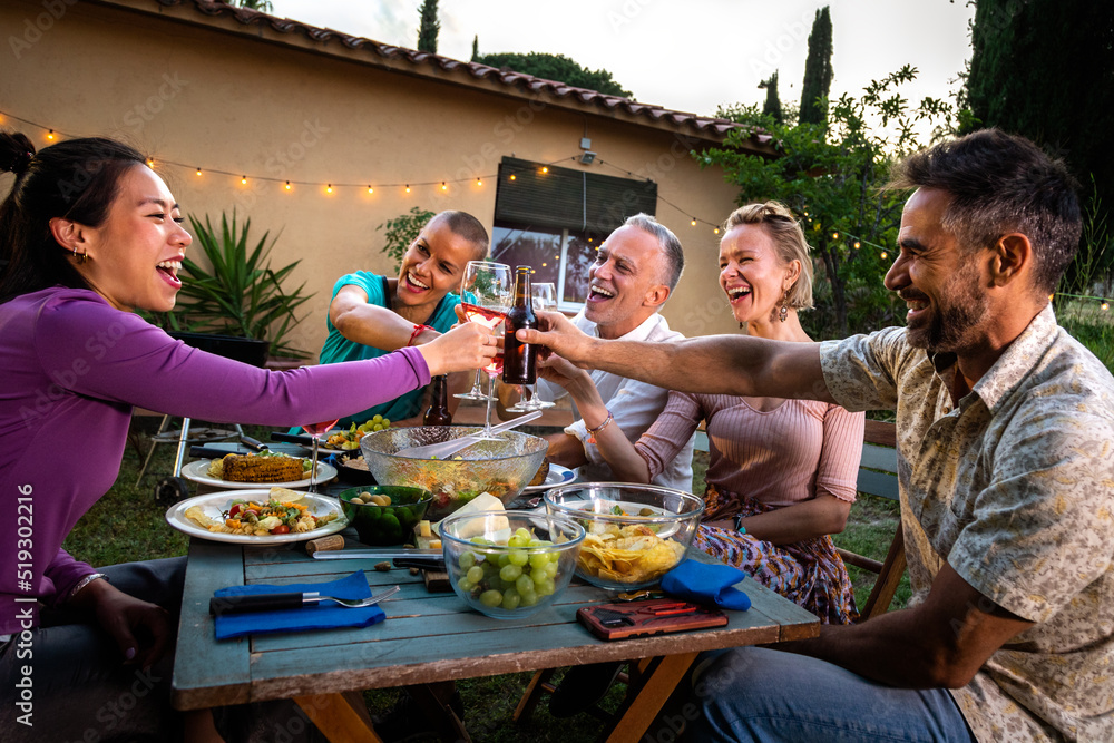Asian woman having a celebratory toast with wine, laughing and having fun during barbecue garden dinner party at sunset. Asian woman having a celebratory toast with wine, laughing and having fun during barbecue garden dinner party at sunset.