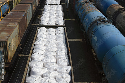 Freight wagons with mineral fertilizers at the railway station. Sending wagons for export.