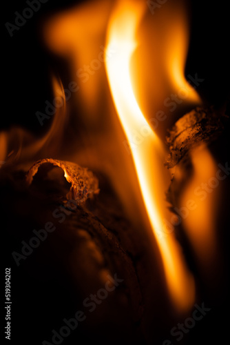 Fire close-up and red orange yellow color detail texture and abstract shape on black background