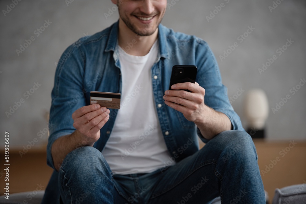 Caucasian man hold cellphone make online payment purchase with credit card, shopping online on smartphone Caucasian man hold cellphone make online payment purchase with credit card, shopping online on smartphone